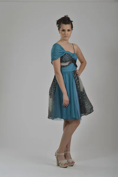 Elegant woman in fashionable dress posing in the studio — Stock Photo, Image