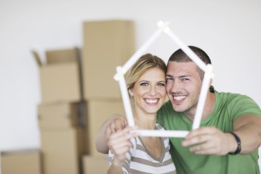 Young couple moving in new home clipart