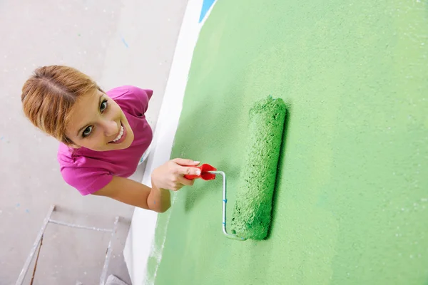 Happy smiling woman painting interior of house — Stock Photo, Image