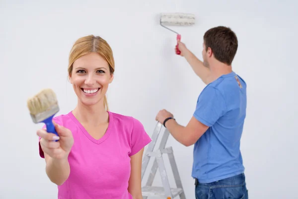 stock image Happy couple paint wall at new home