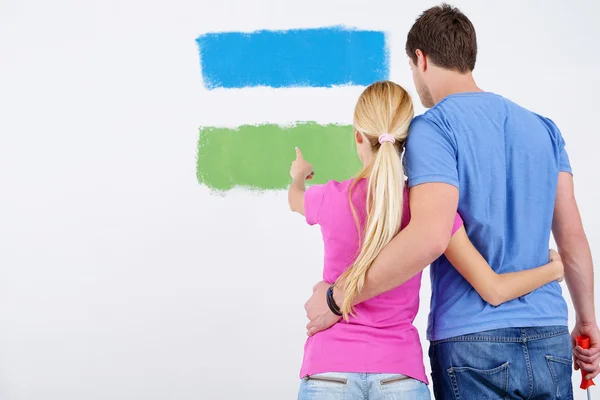 Happy couple paint wall at new home Royalty Free Stock Photos