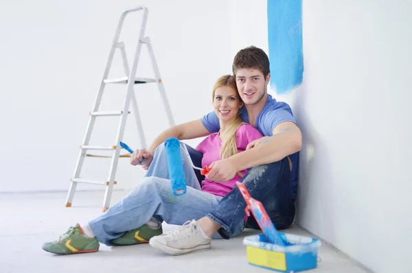 stock image Happy young cople relaxing after painting in new home