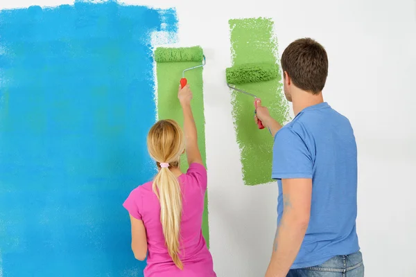 Szczęśliwy para farby ściany w nowym domu — Zdjęcie stockowe