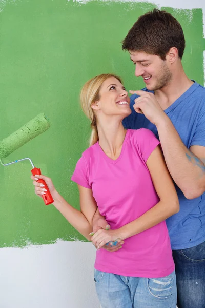 stock image Happy couple paint wall at new home