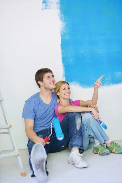 Jovem cople feliz relaxante depois de pintar em nova casa Fotografias De Stock Royalty-Free