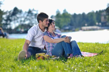 Happy young couple having a picnic outdoor