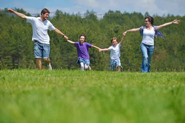 Boldog fiatal család szabadban szórakozik — Stock Fotó