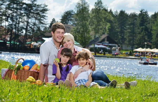 Happy family playing together in a picnic outdoors — Stock Photo, Image