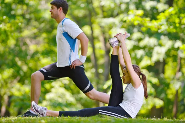 Couple doing stretching exercise after jogging Royalty Free Stock Photos