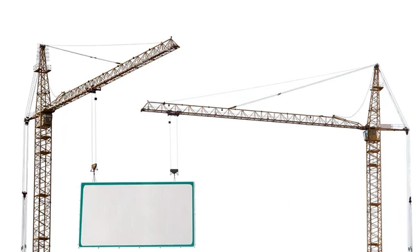 Two yellow hoisting cranes and advertisement hoardin — Stock Photo, Image