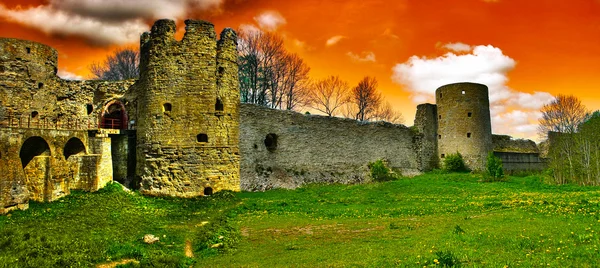 Medieval fortification under orange sky — Stock Photo, Image