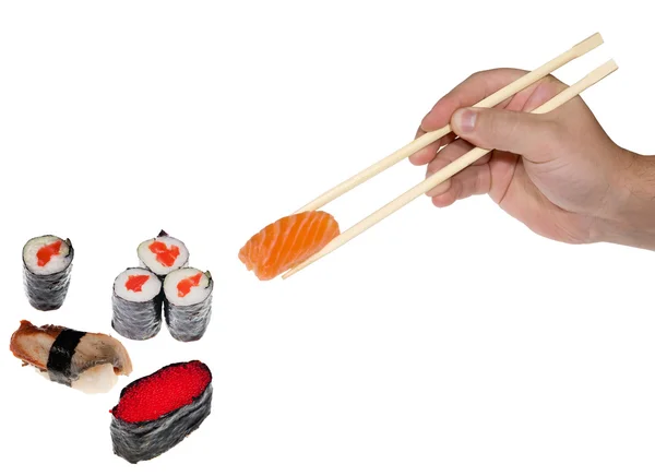 Main avec baguettes et sushis sur blanc — Photo