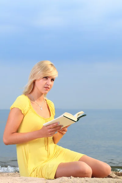 Stock image Woman reading book girl yellow dress