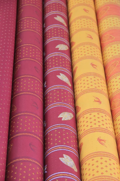 Rolls of Provencal textile on a market stall — Stock Photo, Image