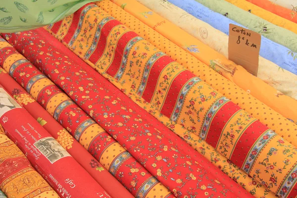 Rolls of Provencal textile on a market stall — Stock Photo, Image