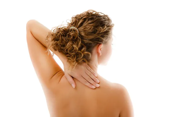Жінка масажує біль назад ізольовано на білому тлі — стокове фото