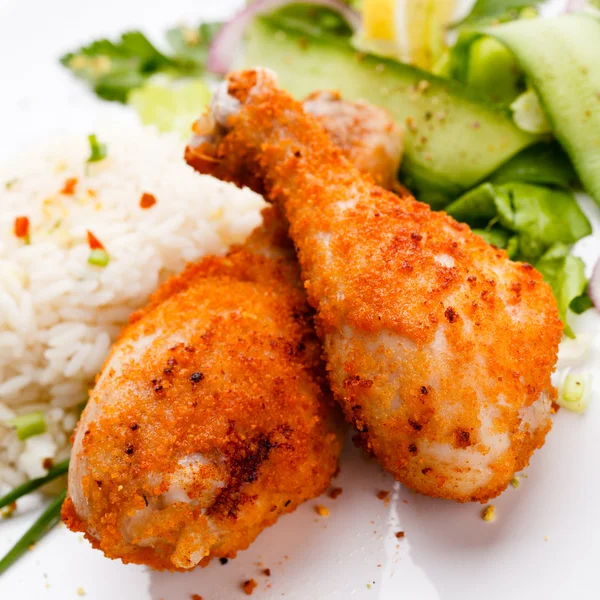 stock image Roasted chicken drumsticks, rice and vegetables