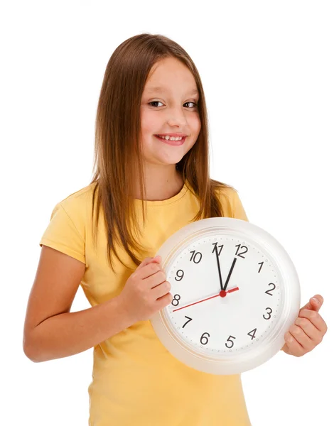 Menina segurando relógio de parede isolado no fundo branco — Fotografia de Stock