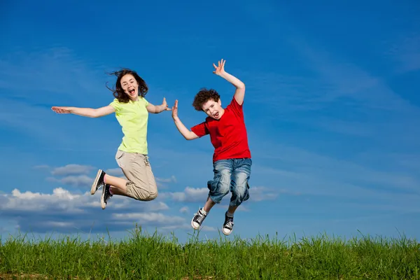 Girl and boy running, jumping outdoor Stock Image