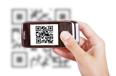 Scanning QR code with mobile phone clipart