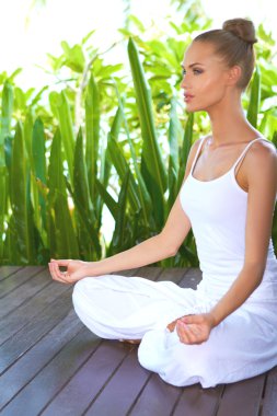 Woman in deep contemplation while meditating clipart