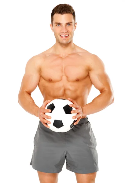 Přizpůsobit svalnatý muž s fotbalovým míčem na bílém pozadí — Stock fotografie