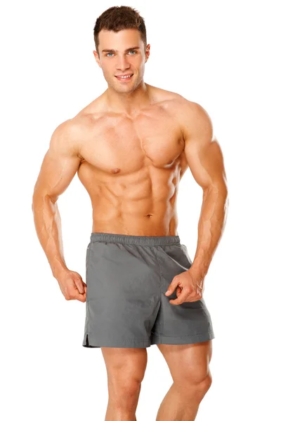 Ritratto di un atleta maschio muscoloso su bianco — Foto Stock