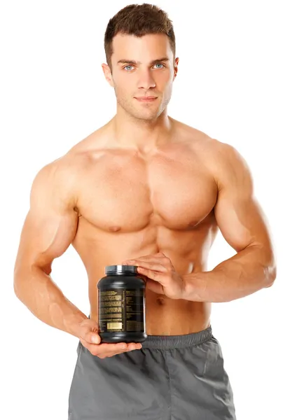 Homem muscular segurando recipiente de suplementos de treinamento — Fotografia de Stock