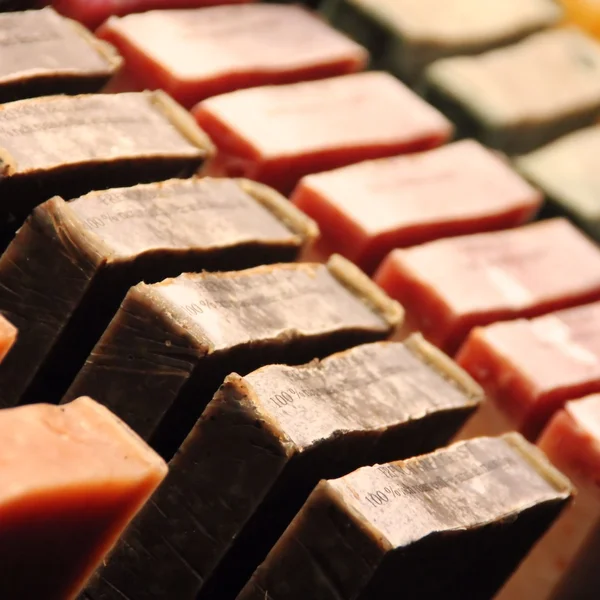 Rows of handmade soap displayed in a market