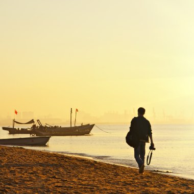 Photographer looking for beautiful views of the sea. clipart