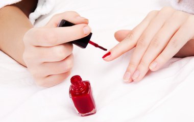 Woman applying polish clipart