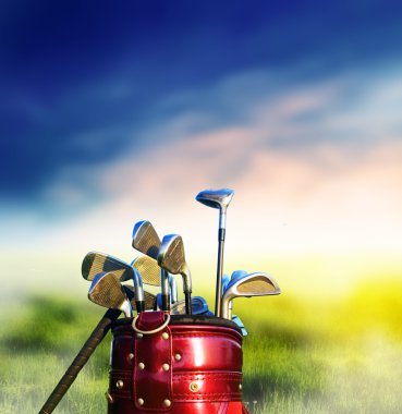 Golf clubs on grassy golf course clipart