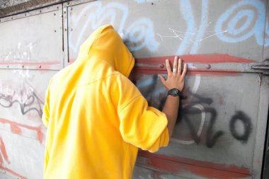 Young man on graffiti grunge wall clipart