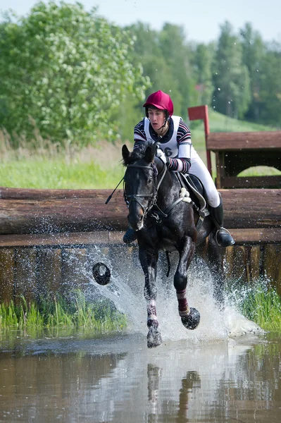 Eventer on horse is overcomes the Water jump — Stock Photo, Image