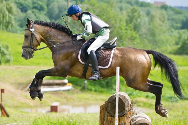 Eventer on horse is overcomes the obstacle — Stock Photo, Image