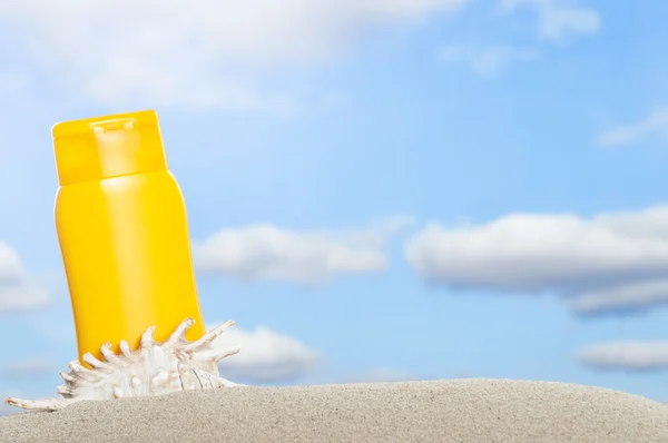 Tube with sun protection on beach — Stock Photo, Image