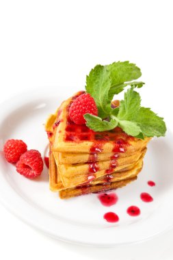 Breakfast : waffles with raspberries, mint and jam on plate