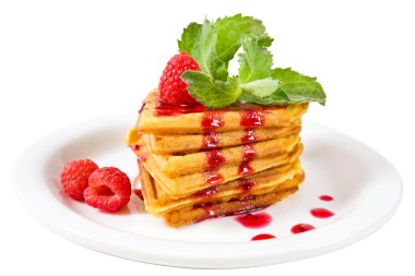 Plate of belgian waffles with fresh raspberries, mint and jam clipart