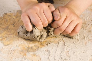 Child hands of a potter clipart