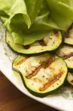 Grilled organic zucchini slices with herbs and spices clipart