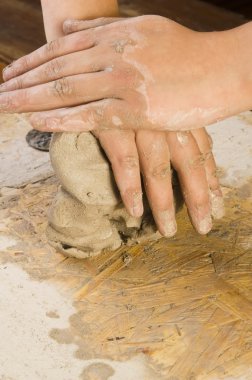 Child hands of a potter clipart