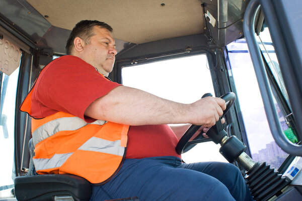 The driver working in the cabin of the truck