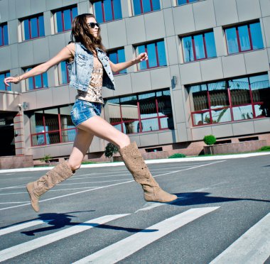 Woman is running down street clipart