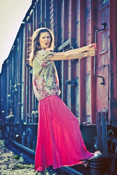 Beautiful woman jump on the train — Stock Photo, Image