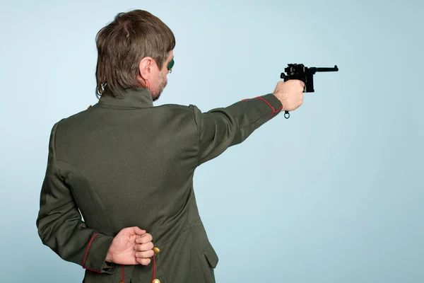 Military officer fires a gun — Stock Photo, Image