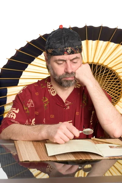 Man in chinese costume reads — Stock Photo, Image