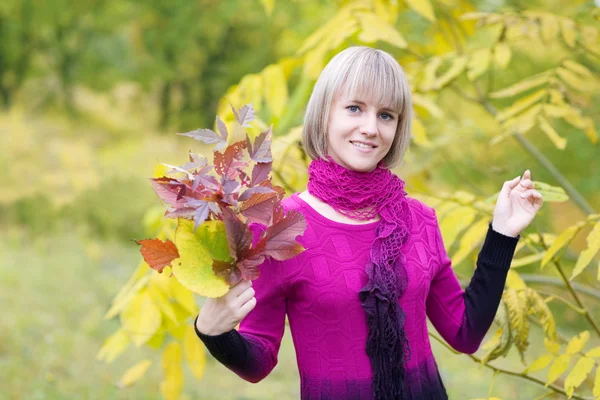 Beautiful girl with a branch foliage — Stock Photo, Image