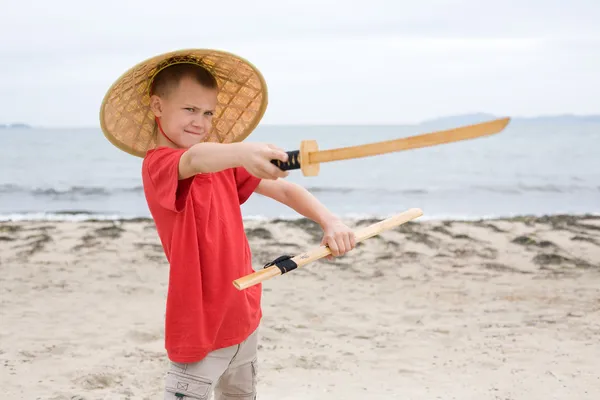 Boy plays with a samurai sword — Stock Photo, Image