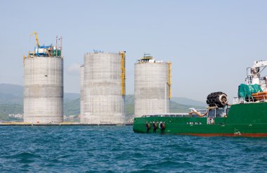Tug towing base oil platform clipart