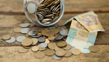 Ukrainian coins and hryvnas shows poverty clipart